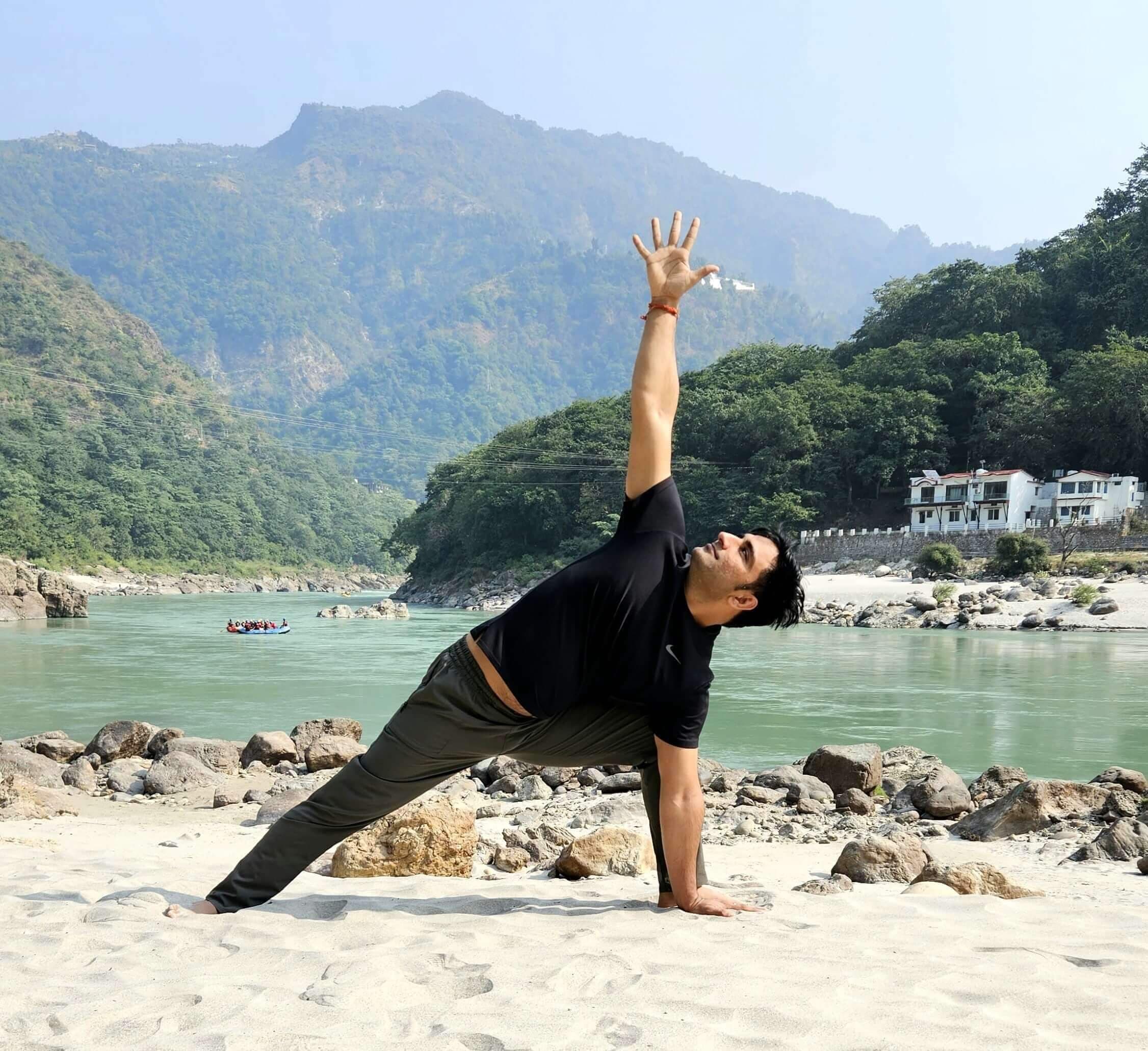 Shubham in a side angle pose on a riverbank